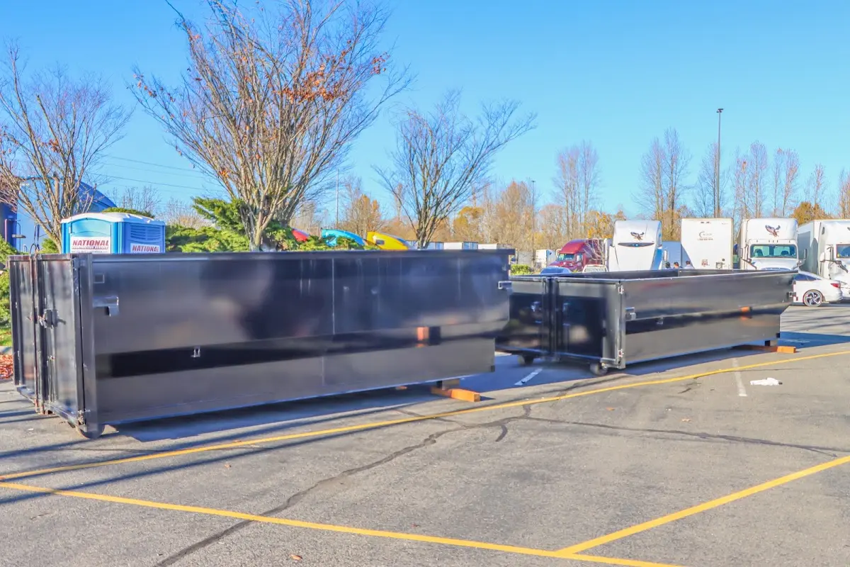 Professional dumpster rental service with roll-off container on residential driveway in Carmichael